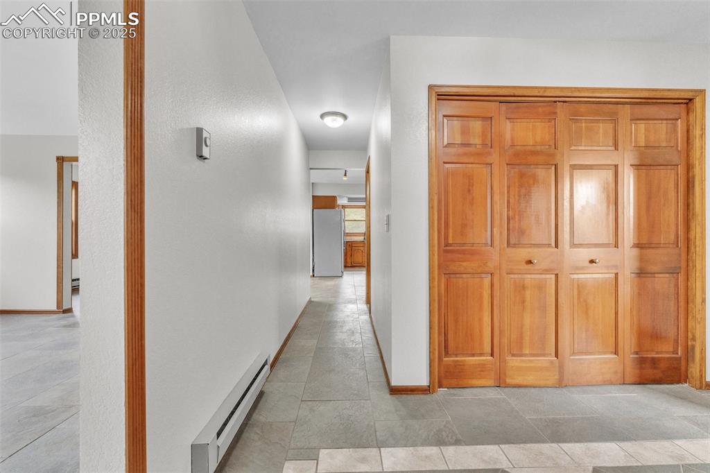 Image 6 of 43: Corridor with a baseboard heating unit