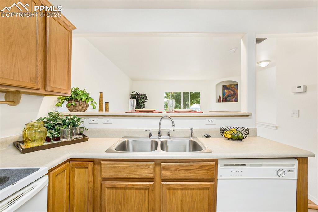 Image 11 of 27: Kitchen with ceramic tile, and white appliances