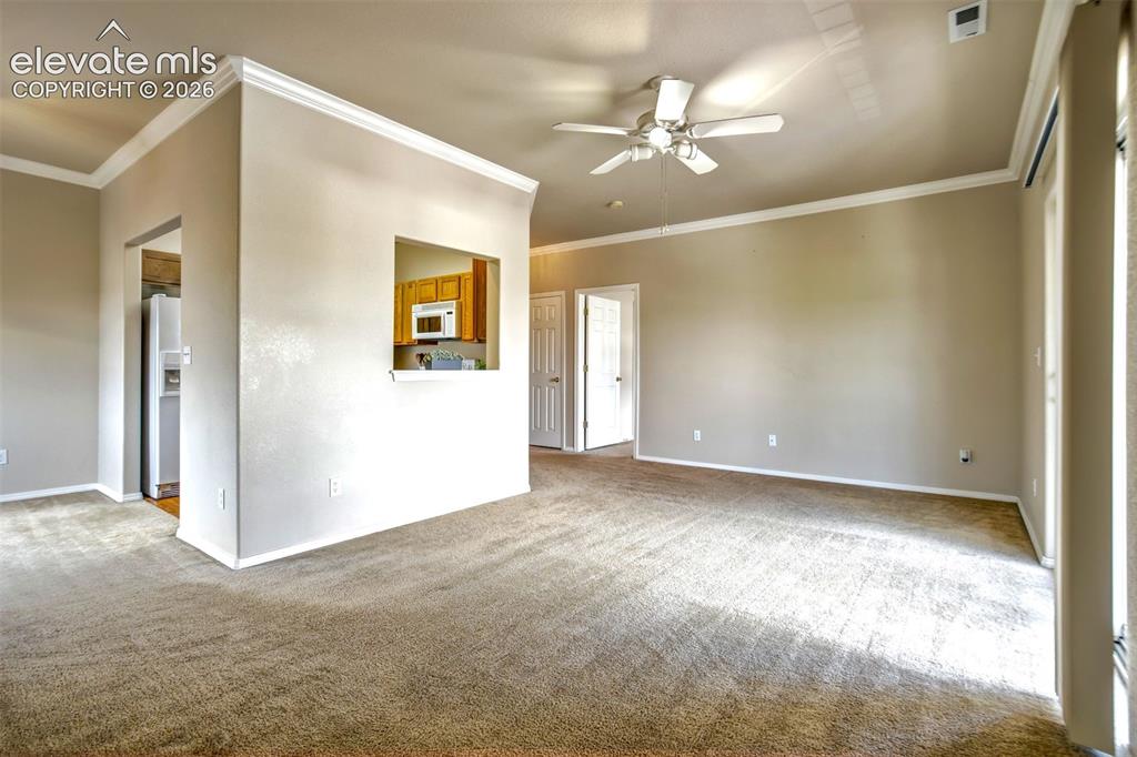 Image 12 of 50: View of the living room, dining room and kitchen entrance