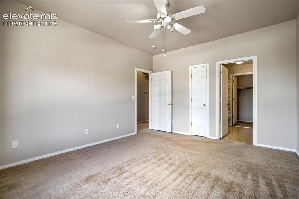 Image 26 of 50: Attached full bathroom with walk-in closet and another closet with shelving