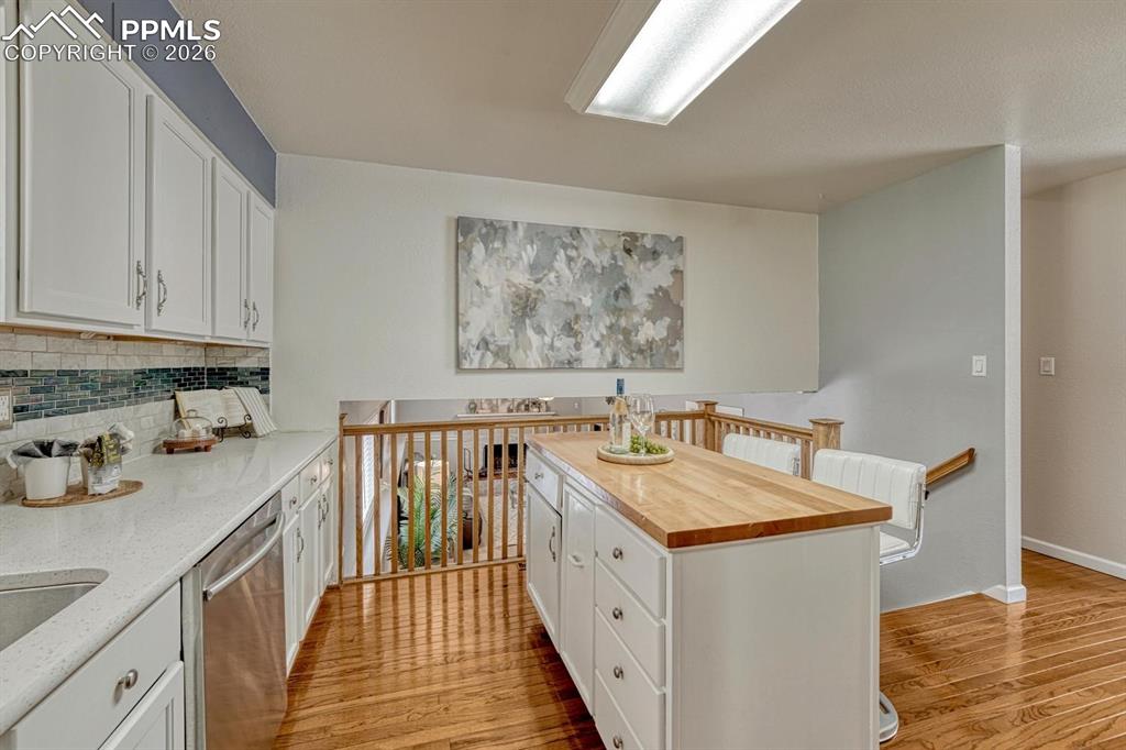 Image 10 of 42: The open layout allows you to overlook the lower-level family room right fr