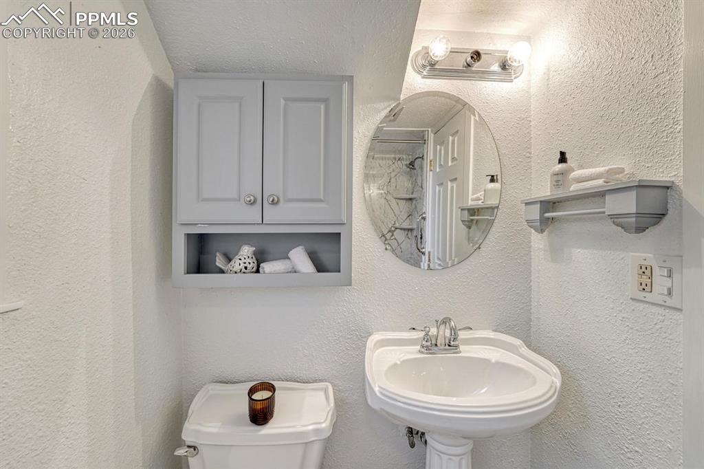 Image 20 of 42: Anyone downstairs will appreciate the beautifully renovated 3/4 bathroom, f