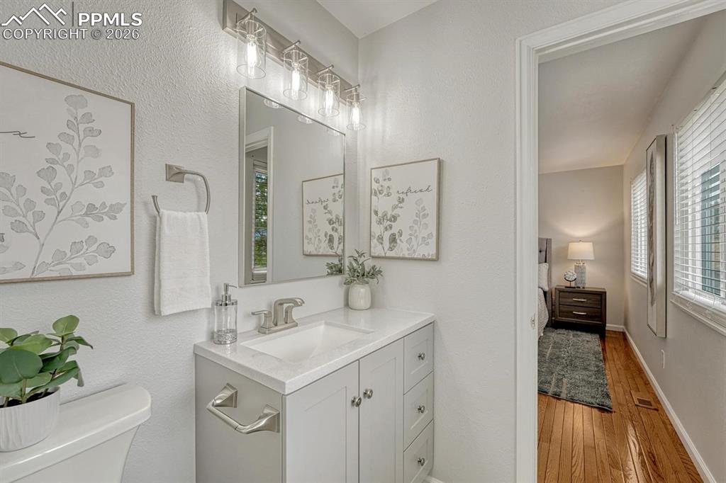 Image 26 of 42: The primary bathroom also boasts a sleek, quartz vanity with plenty of draw