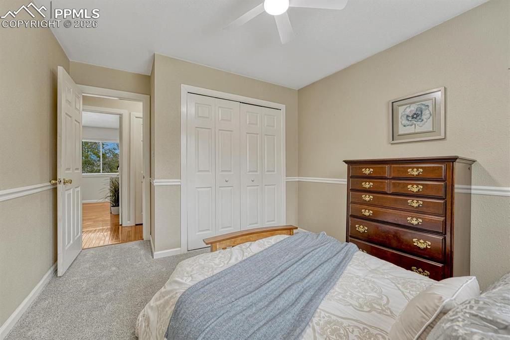 Image 28 of 42: A spacious double-door closet and bright windows make this upper-level bedr