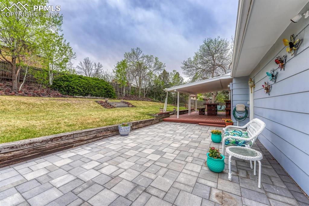 Image 34 of 42: Extend your outdoor living onto this beautiful paver patio, a perfect sunny