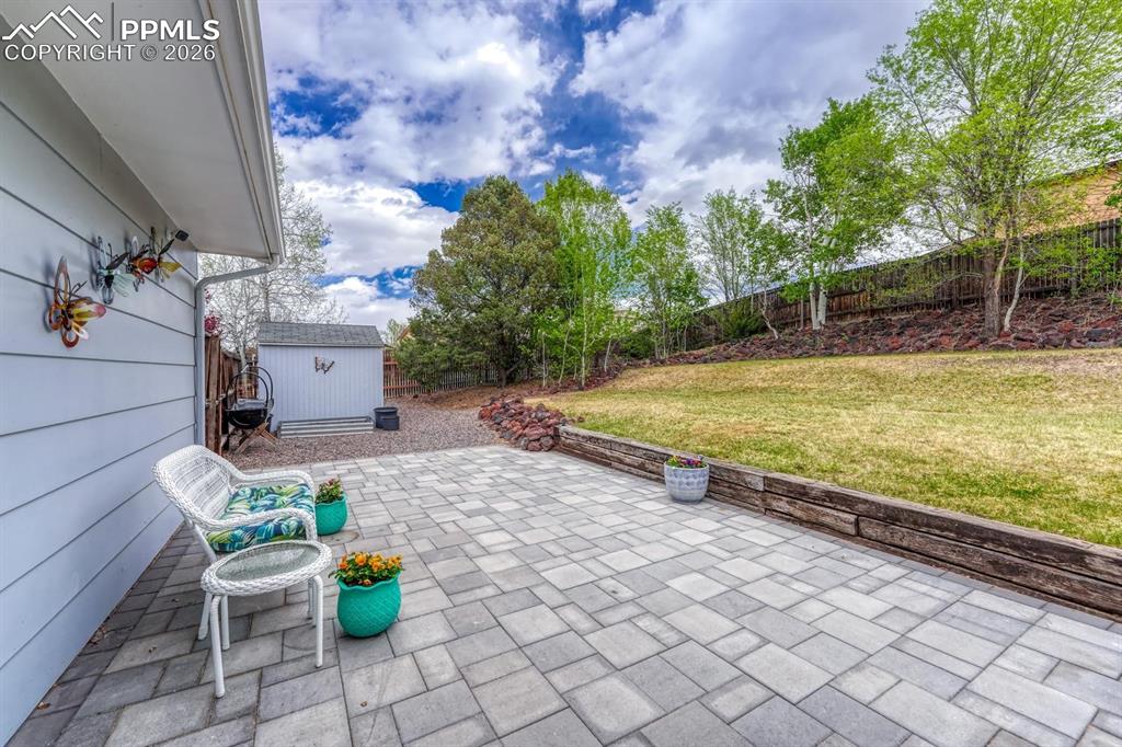 Image 35 of 42: The fully fenced backyard offers a safe haven for pets and play, complete w