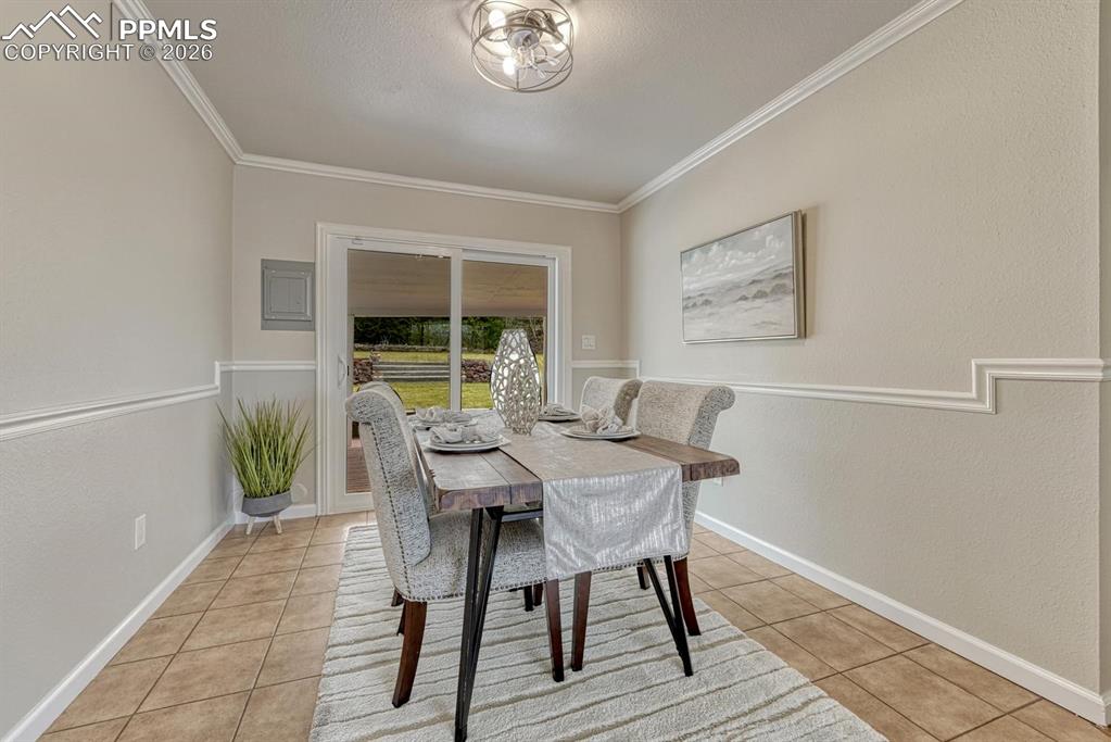 Image 7 of 42: Host casual meals or formal family gatherings in this dining room, which fe