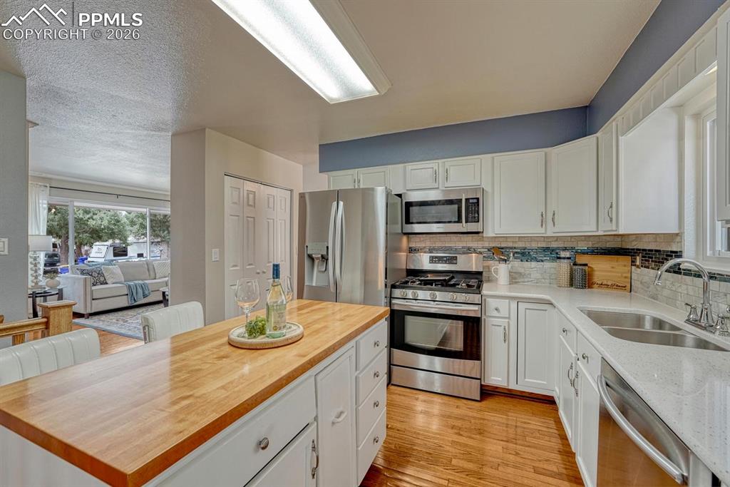 Image 8 of 42: An updated kitchen features quartz countertops, a gas stove, and Samsung st