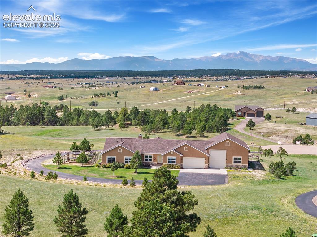 Caption: Beautiful ranch style home with stucco and stone exterior. Situated on 3.21 acres, stunning Pikes Pe