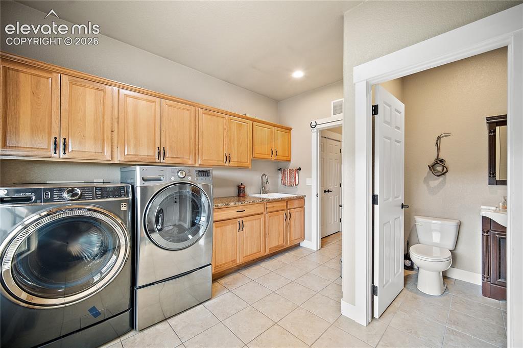 Image 13 of 42: 1/2 bath located off the laundry/mud room and close to the garage and works