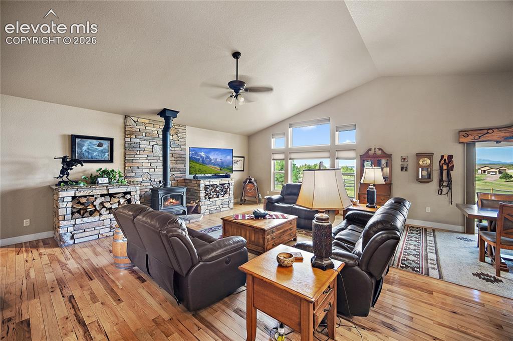 Image 14 of 42: Living room with vaulted ceilings, floor to ceiling windows and custom wood