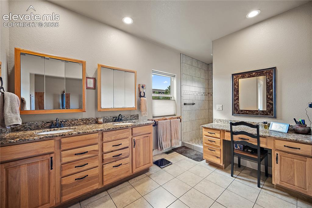 Image 20 of 42: Attached primary bath with oversized walk in shower, double vanity as well