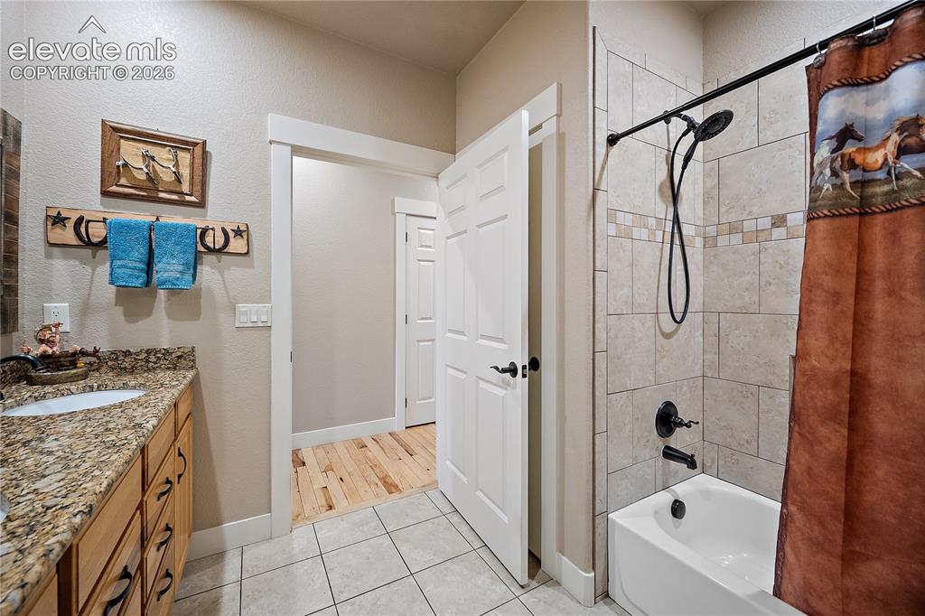 Image 24 of 42: Full bath with double vanity.