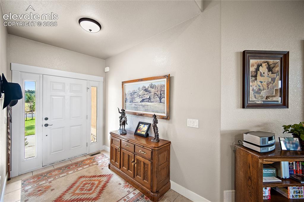 Image 4 of 42: Spacious entry welcomes family and friends.