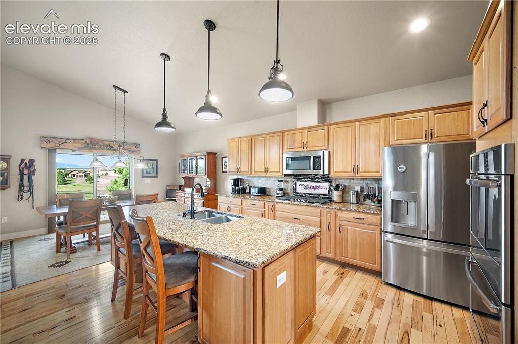 Image 6 of 42: Huge island, granite, SS, double oven and gas range.