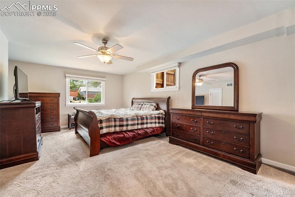 Image 10 of 29: Bedroom featuring light colored carpet and ceiling fan