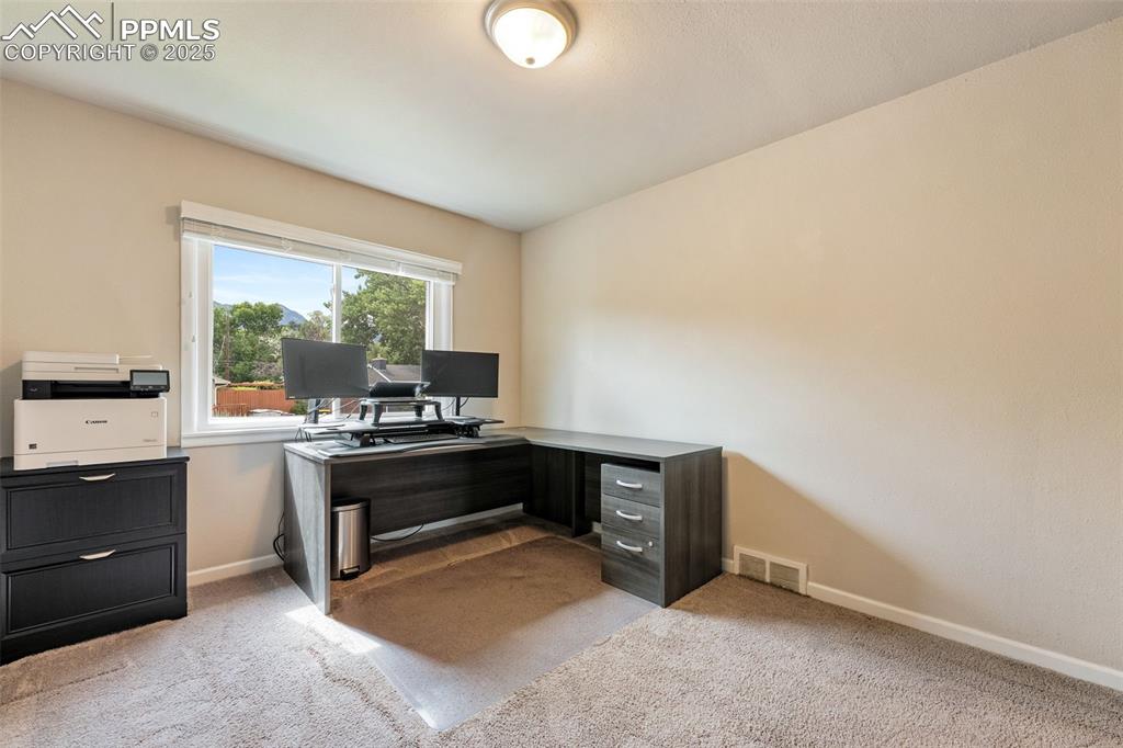 Image 18 of 29: Home office with light colored carpet