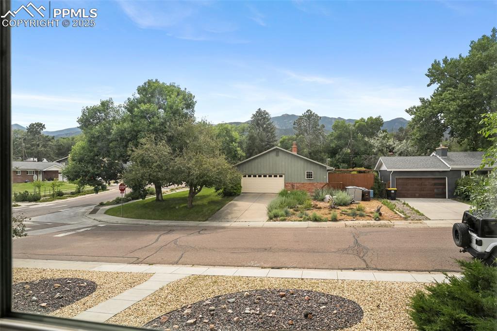 Image 23 of 29: View of front facade featuring a mountain view and driveway