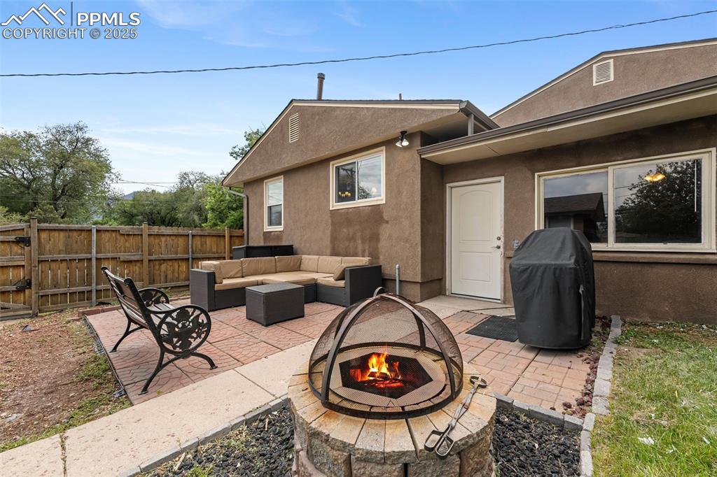 Image 24 of 29: View of patio with an outdoor living space with a fire pit and a grill