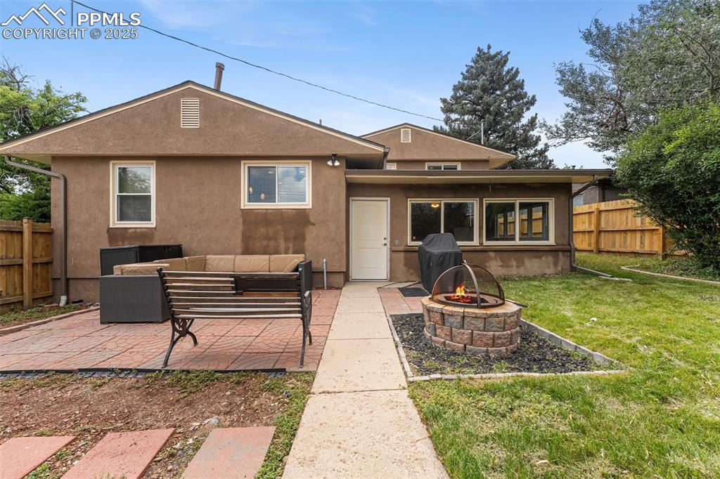 Image 25 of 29: Rear view of house with an outdoor living space with a fire pit, a patio ar