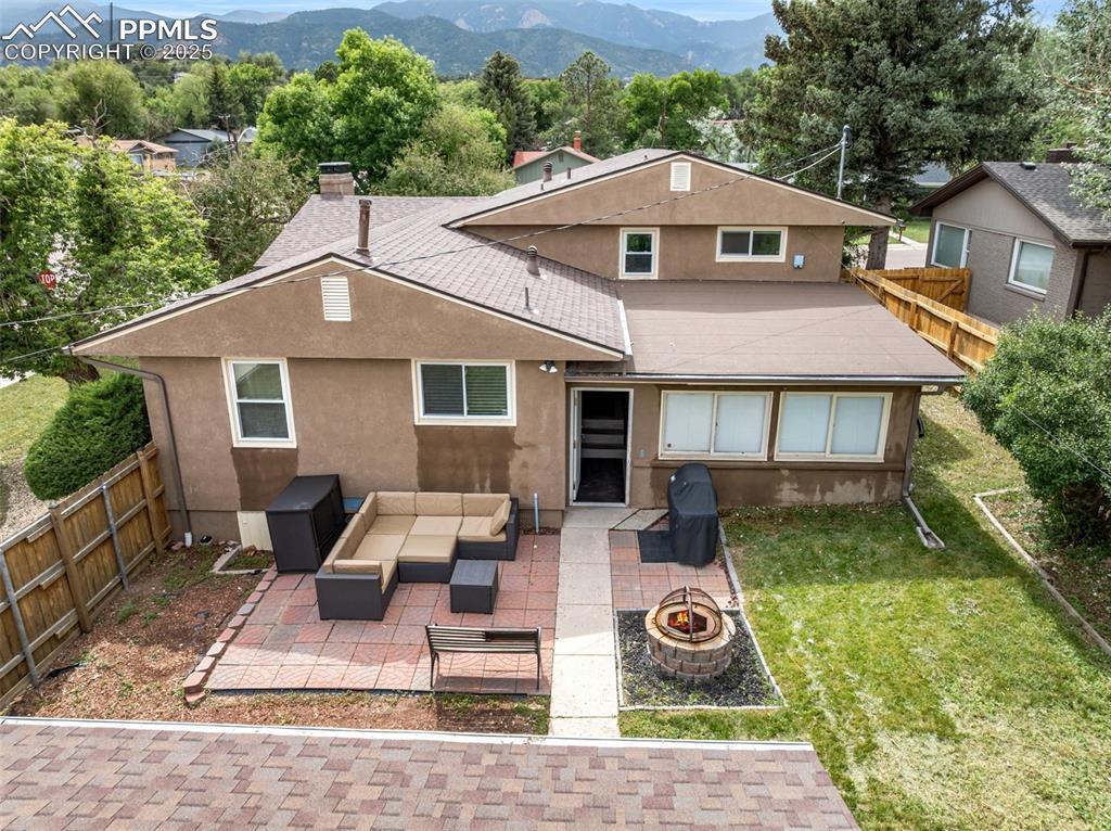 Image 26 of 29: Rear view of house with stucco siding, a patio, an outdoor living space wit