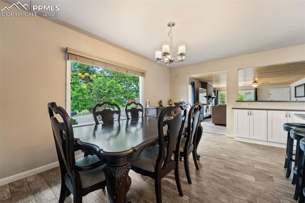 Image 8 of 29: Dining space featuring a chandelier and light wood-style floors