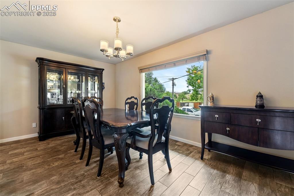 Image 9 of 29: Dining room featuring a chandelier and wood finished floors