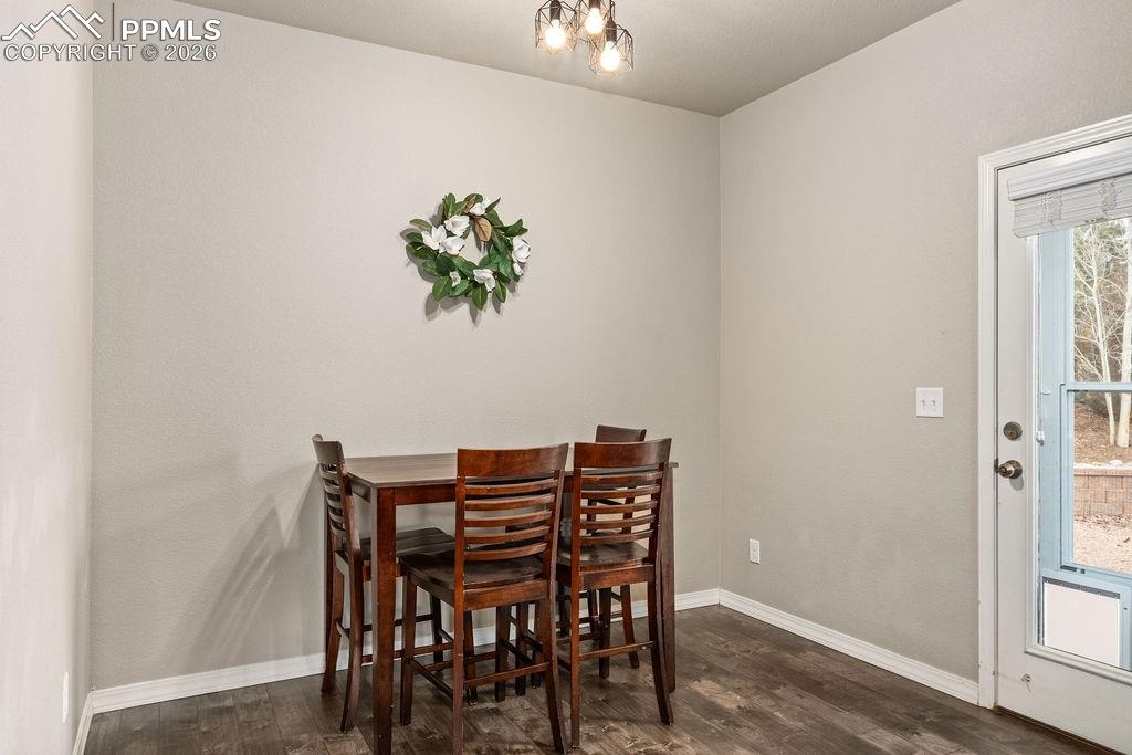 Image 15 of 43: Kitchen with stainless steel appliances, dark wood finish cabinets, dark wo