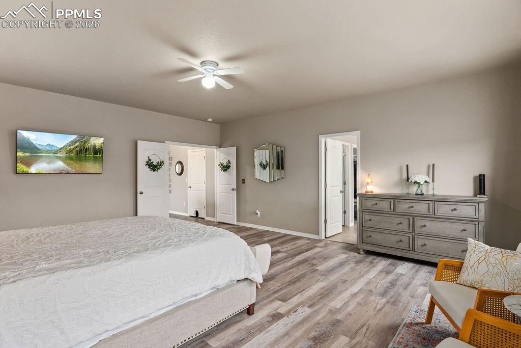Image 26 of 43: Upper floor primary bedroom featuring light wood finished floors and ceilin