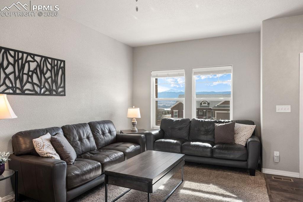 Image 3 of 43: View of sitting room with views of Pikes Peak from window.