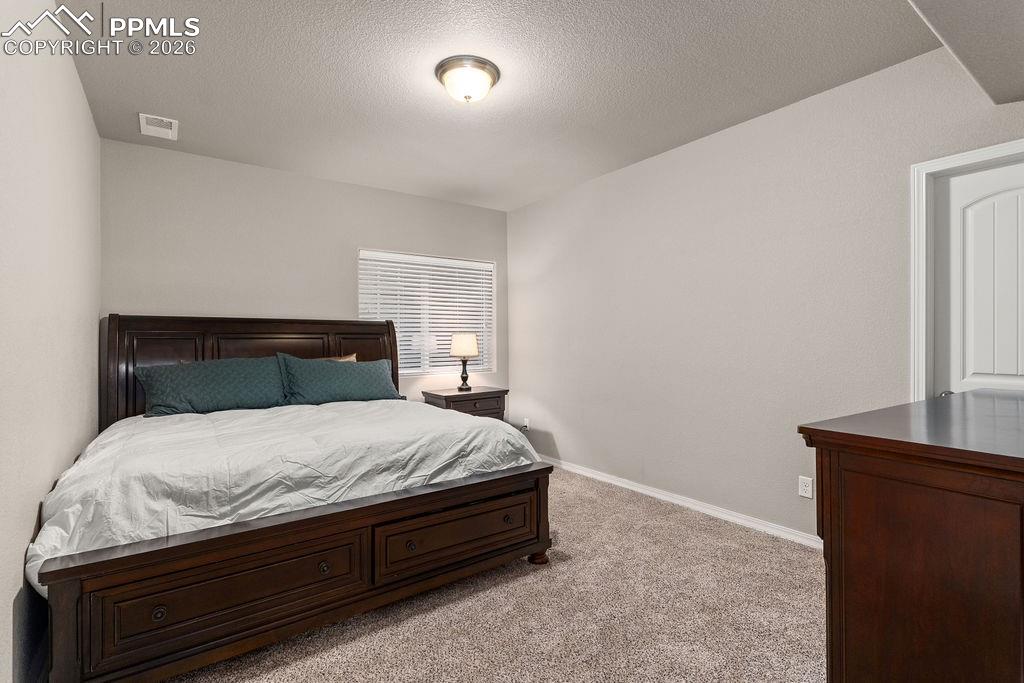 Image 40 of 43: Basement bedroom #2 with an egress window.