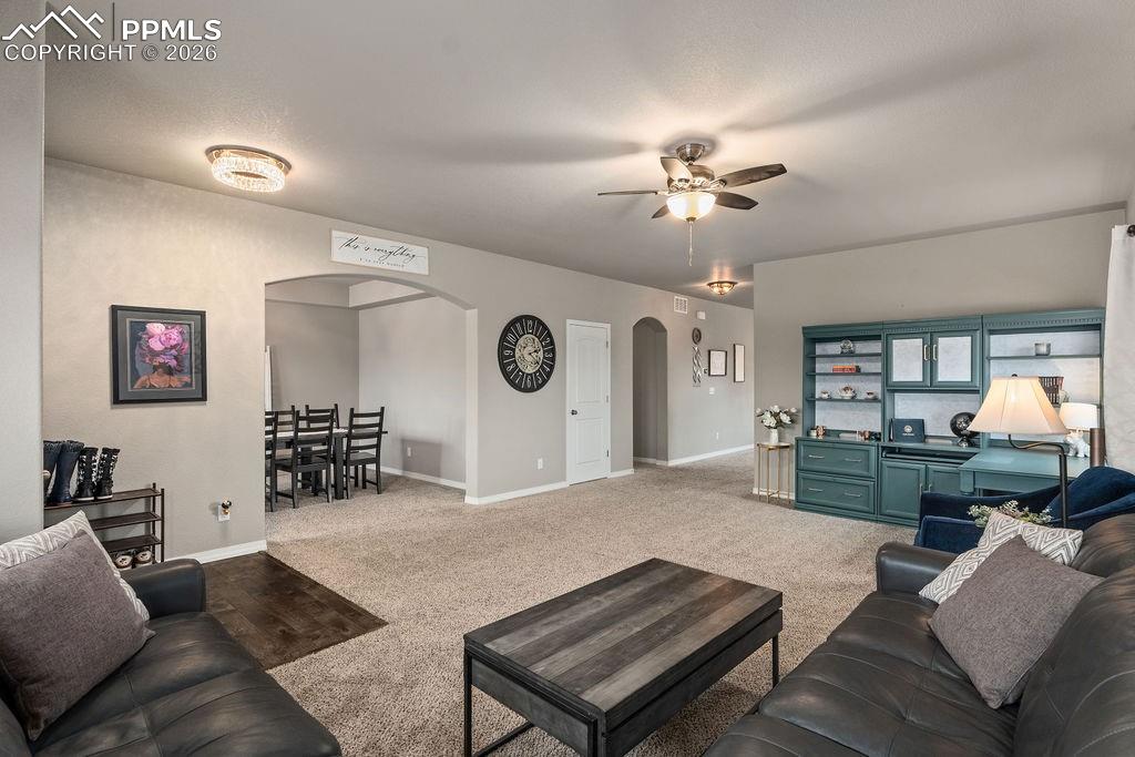 Image 5 of 43: Sitting room featuring arched walkways, ceiling fan, and carpet floors
