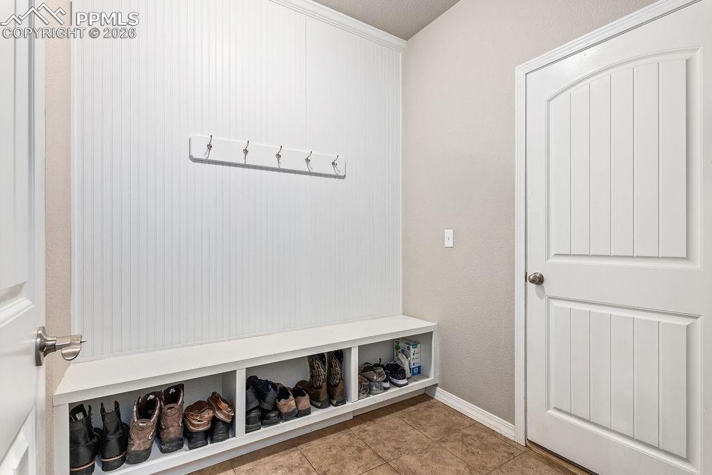 Image 7 of 43: Mudroom featuring light tile patterned flooring and baseboards