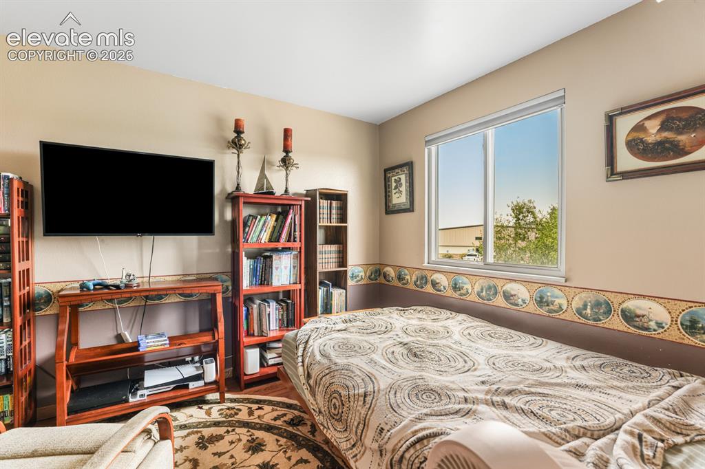 Image 15 of 33: Bedroom featuring a single window with white trim, light beige walls, and w