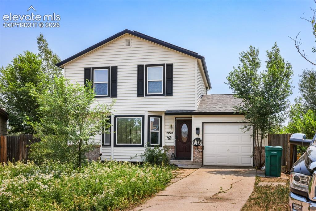 Image 3 of 33: White siding exterior featuring black window shutters and trim
