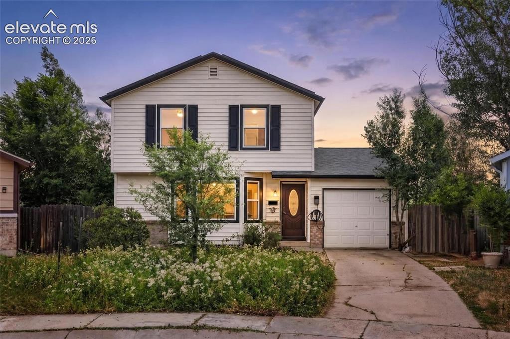 Image 33 of 33: Two-story residence featuring white horizontal siding and black window shut