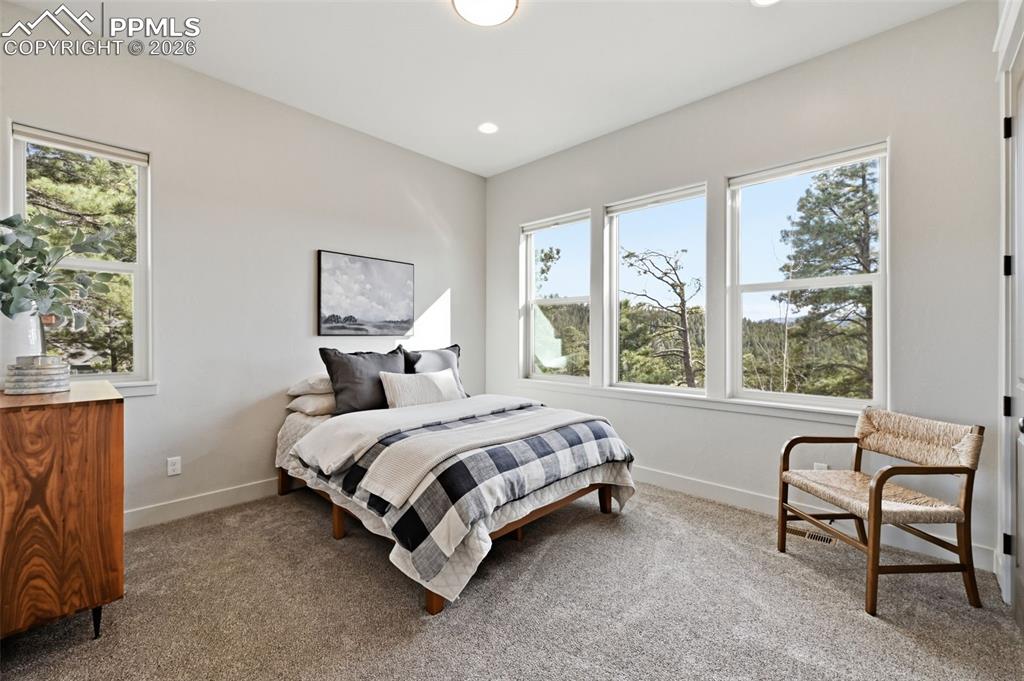 Image 34 of 49: Main level bedroom with views of Pikes Peak!