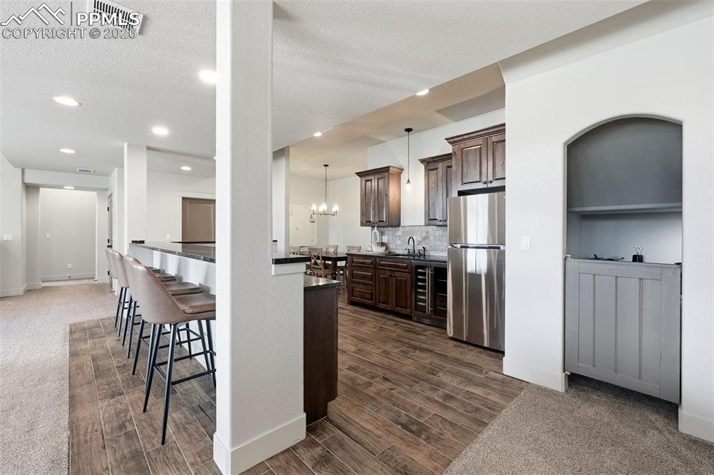 Image 39 of 49: Spacious wet bar and kitchenette is larger than most kitchens!