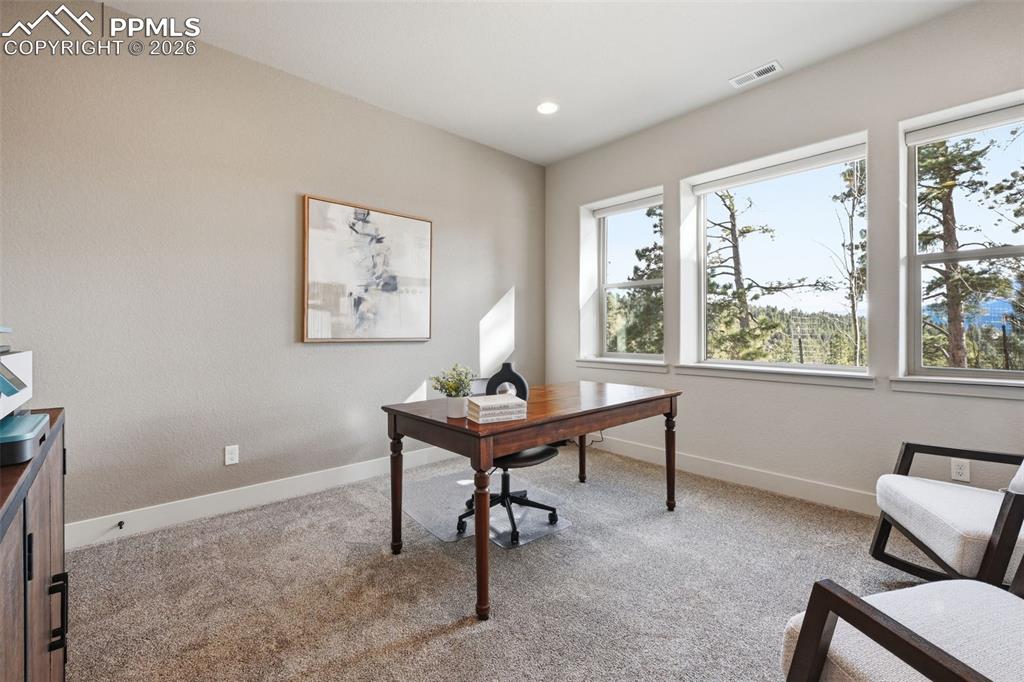Image 44 of 49: Office or extra bedroom with large windows and views of Pikes Peak!