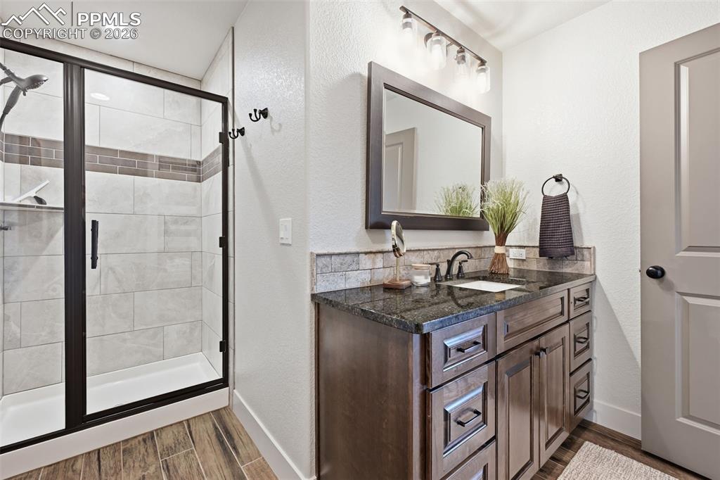 Image 45 of 49: Large basement bath with walk in shower and large vanity