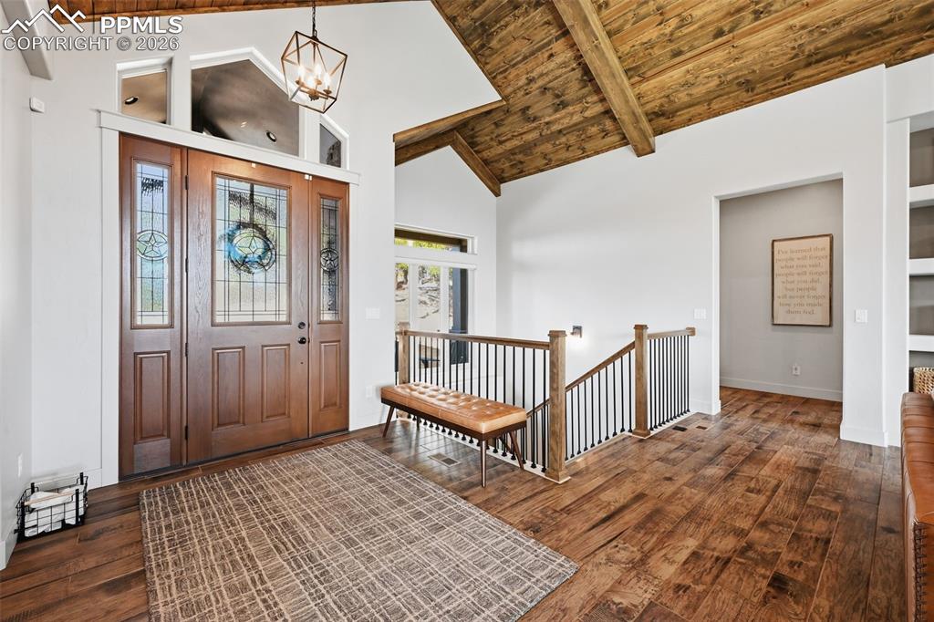 Image 7 of 49: Beautiful entry with vaulted wood ceiling and natural light!