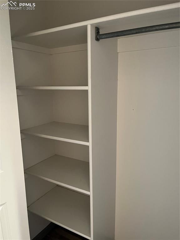 Image 4 of 9: one closet in bathroom has shelving besides a hang up rod. Second closet sp