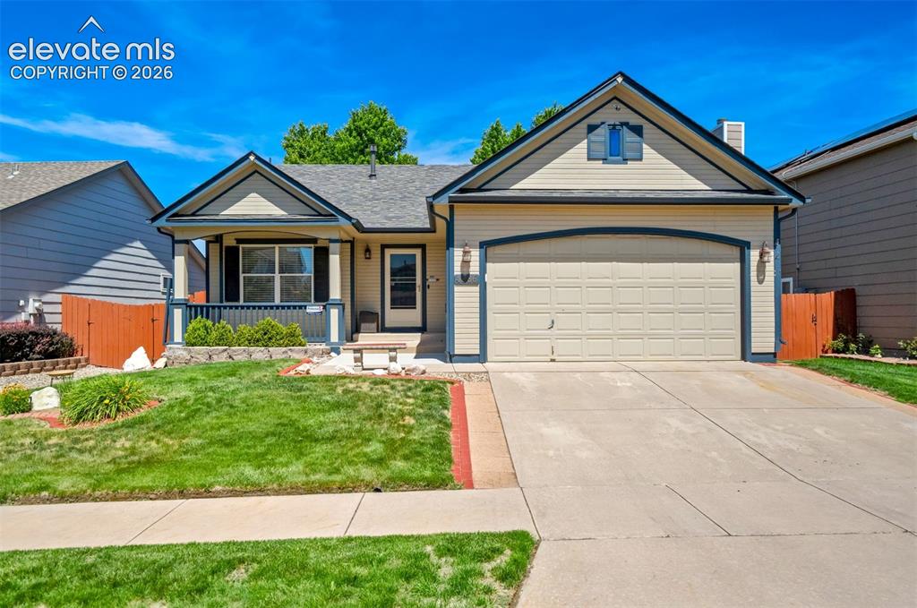 Caption: Beautiful yard and cozy front porch