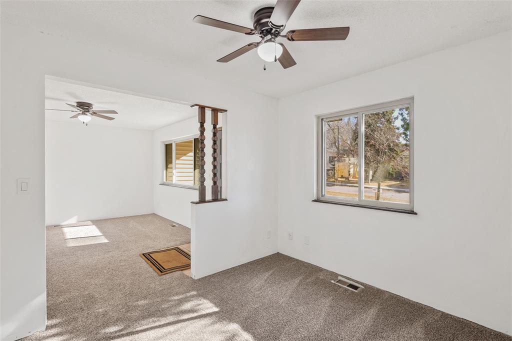 Image 12 of 32: Office or Den with ceiling fan off of the entry