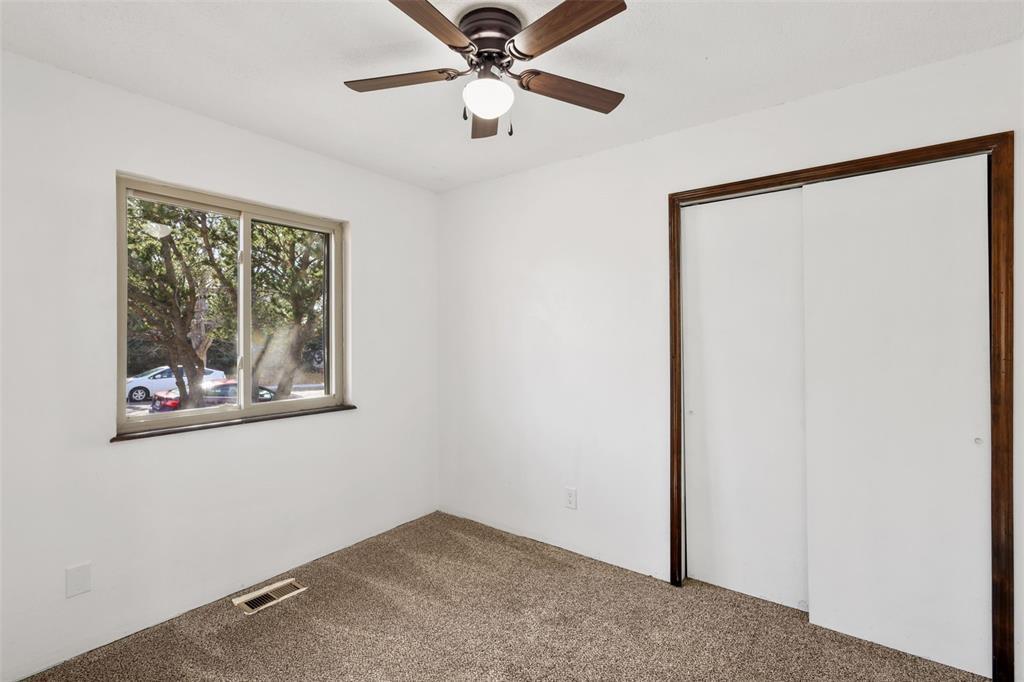 Image 13 of 32: Office or Den with a closet, carpet flooring, and a ceiling fan
