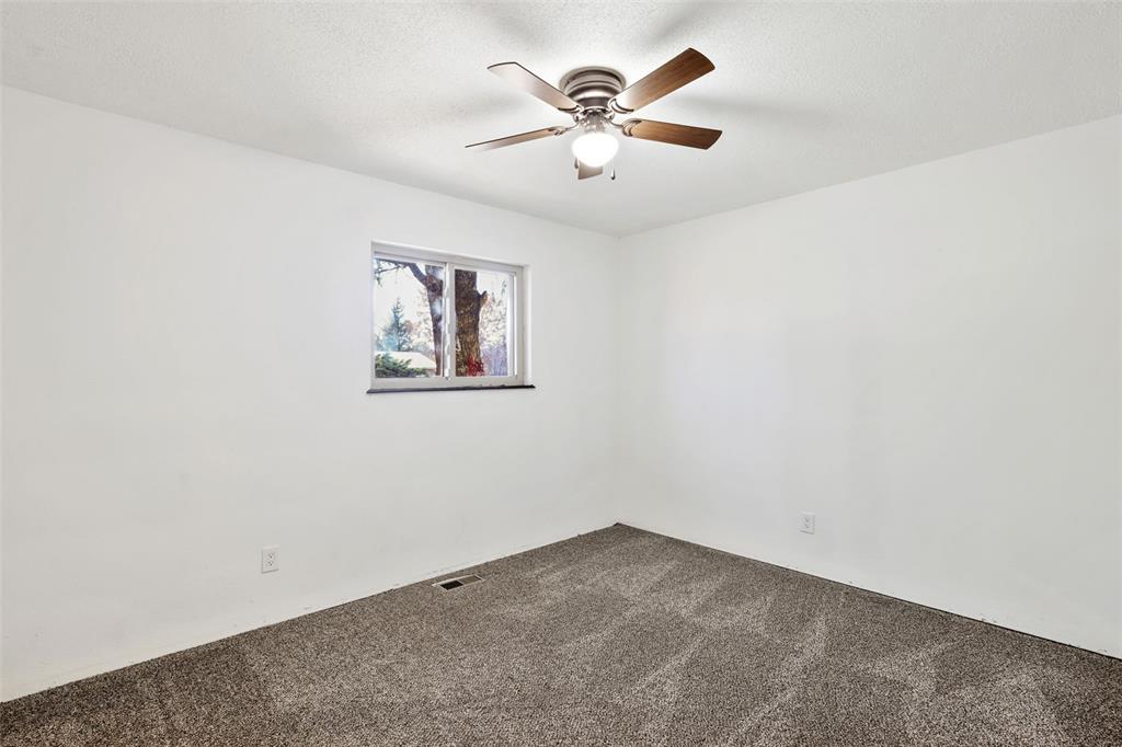 Image 15 of 32: Bedroom #2 with carpet flooring and a ceiling fan