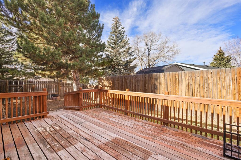 Image 20 of 32: Wooden deck with view of backyard