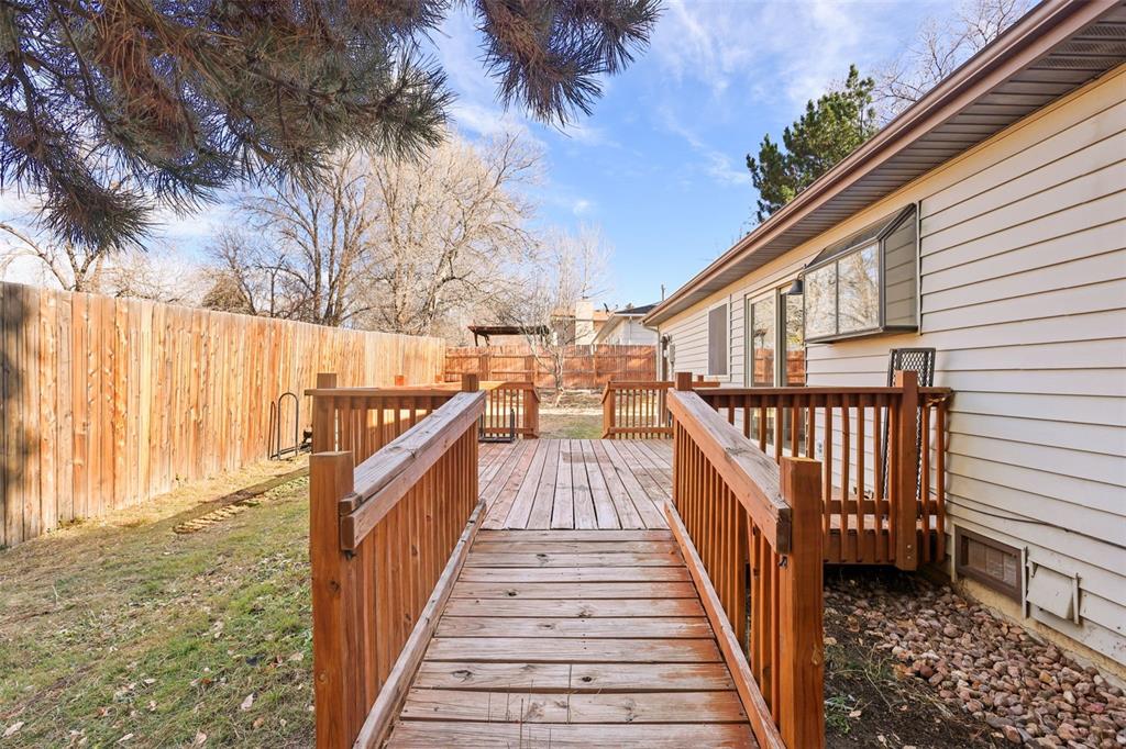Image 23 of 32: Wooden deck with wheelchair accessible ramp