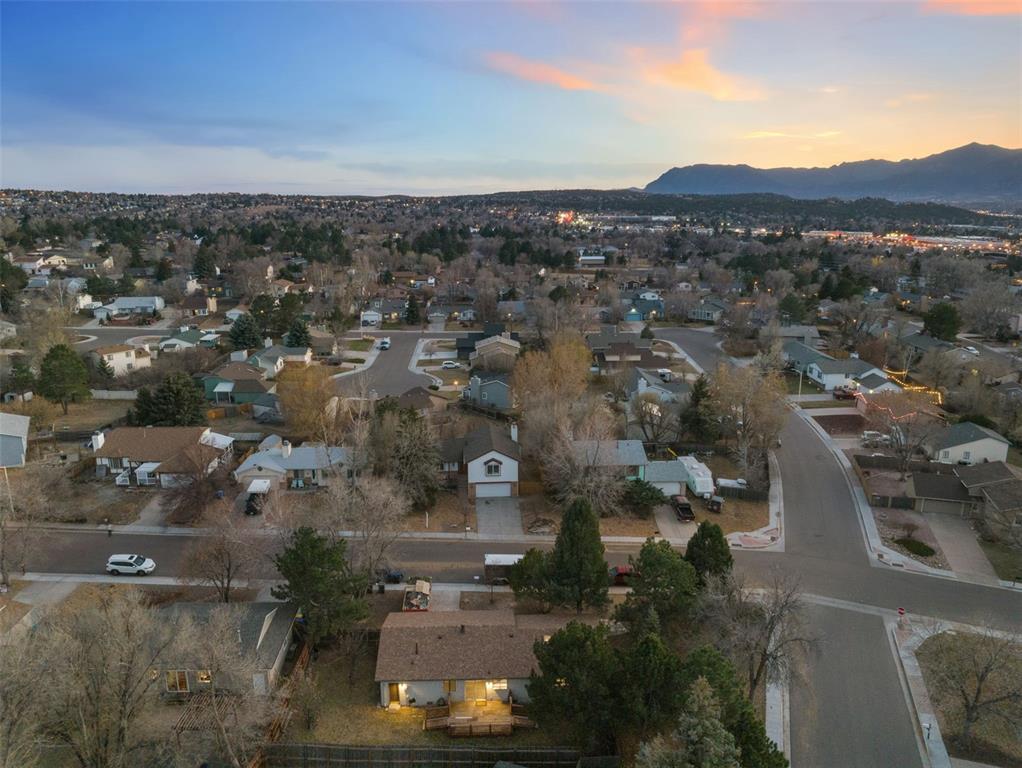 Image 32 of 32: Aerial view of property and surrounding area with view of mountains