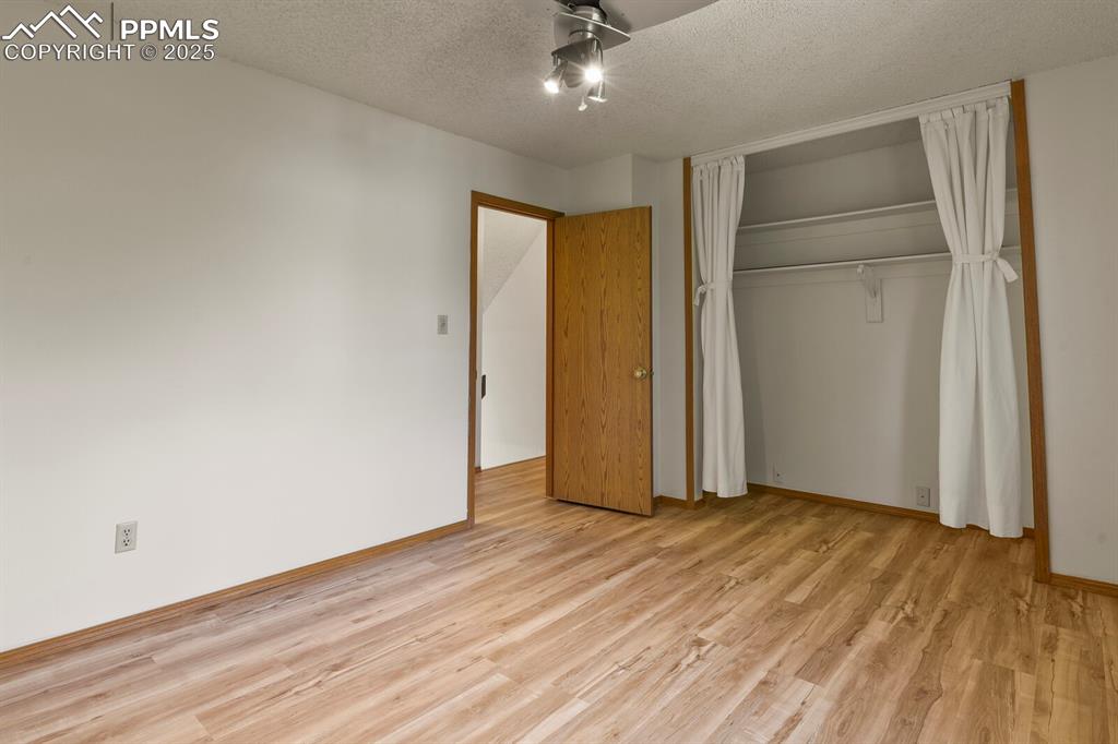 Image 17 of 30: Unfurnished bedroom featuring light wood-style flooring, a closet, and a te